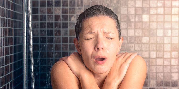 Photo of woman under cold shower