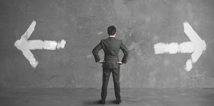 Saying Yes To Life Is Important Decision Photo of a man standing in front of a wall with two arrows pointing at opposite directions