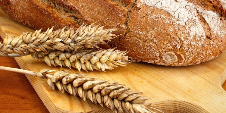 Photo of bread with wheat next to it